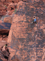 A Climber Ascends a Rock Face