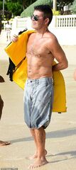 Simon Cowell, 60, goes shirtless as he continues to display his ...