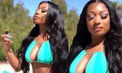 Megan Thee Stallion is buxom in blue bikini as she sprays her ...