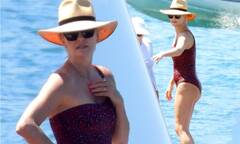 Charlize Theron showcases her incredible frame in a burgundy ...