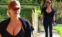 Natasha Oakley wears a plunging crop top as she goes for a walk in ...