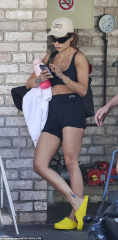 Rita Ora flaunts her super toned physique in a crop top and shorts ...