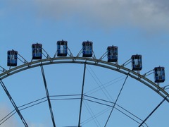 A ferris wheel with a sky in the background. Ferris wheel gondolas ...