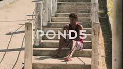 Funky young man sitting on steps and usi... | Stock Video | Pond5