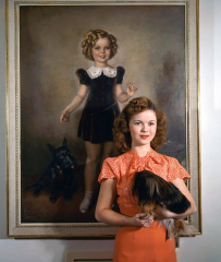 Shirley Temple posing by a painting of young Shirley Temple. 1945 ...