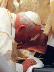 Pope John Paul II Kisses the Foot of a Clergyman