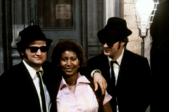 THE BLUES BROTHERS, 1980 directed by JOHN LANDIS Aretha Franklin between John Belushi and Dan Aykro